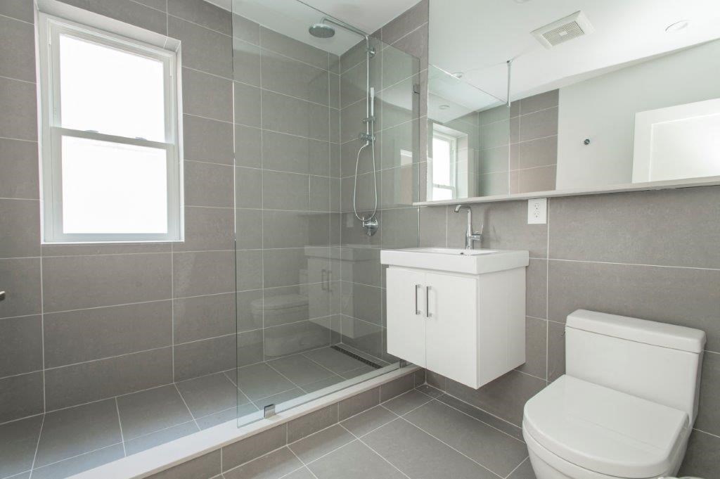 a bathroom with a toilet and a sink and a shower