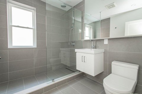 a bathroom with a toilet and a sink and a shower