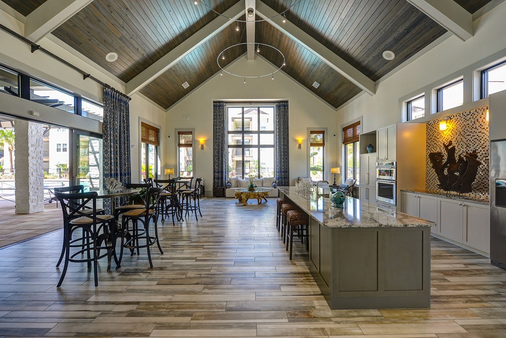 A large open kitchen and dining room with a wooden ceiling and floor at Cabana Club Apartments, Florida