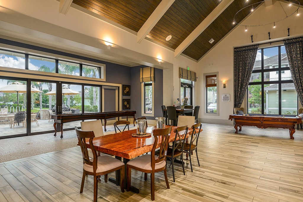 A dining room with a wooden table and chairs at Cabana Club Apartments, Jacksonville, FL, 32256