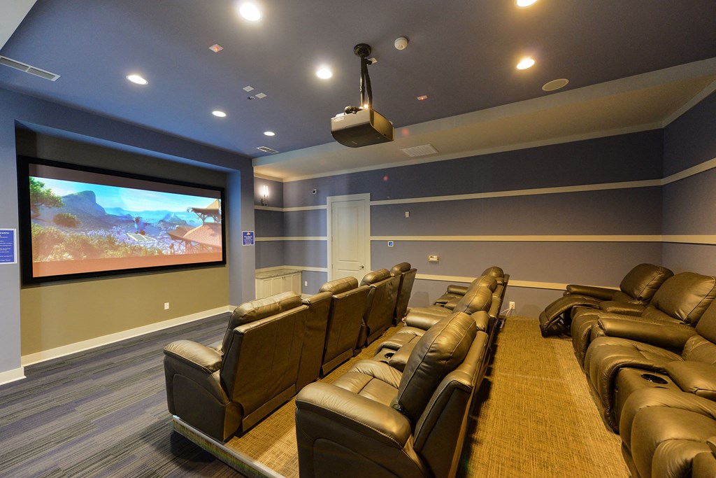 A home theater with a large screen and comfortable seating at Cabana Club Apartments, Jacksonville, 32256