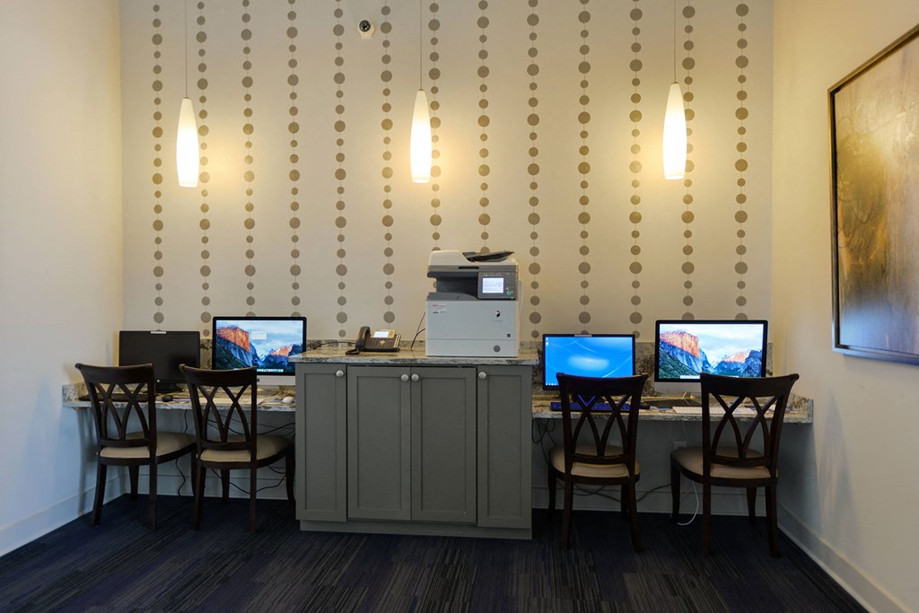 A room with a desk and chairs with a computer on it at Cabana Club Apartments, Jacksonville, Florida