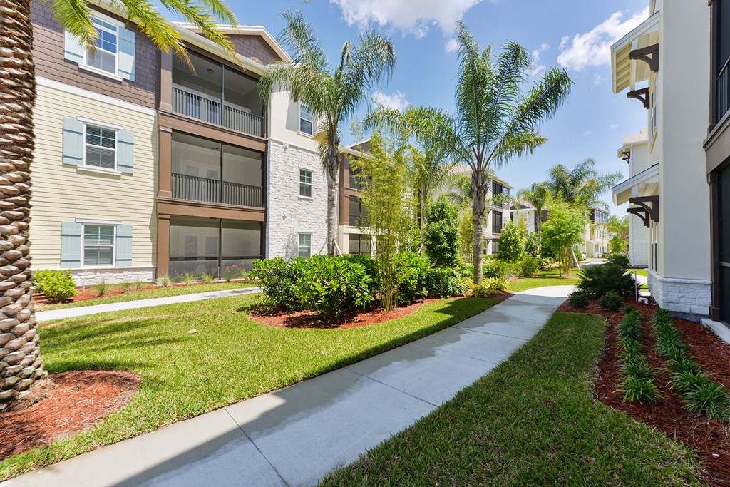 A row of apartment buildings with a sidewalk in front at Cabana Club Apartments, Jacksonville, 32256