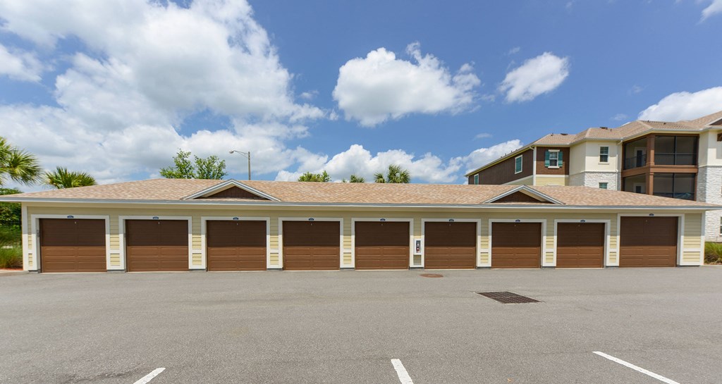 A row of garage doors in front of a building at Cabana Club Apartments, Florida
