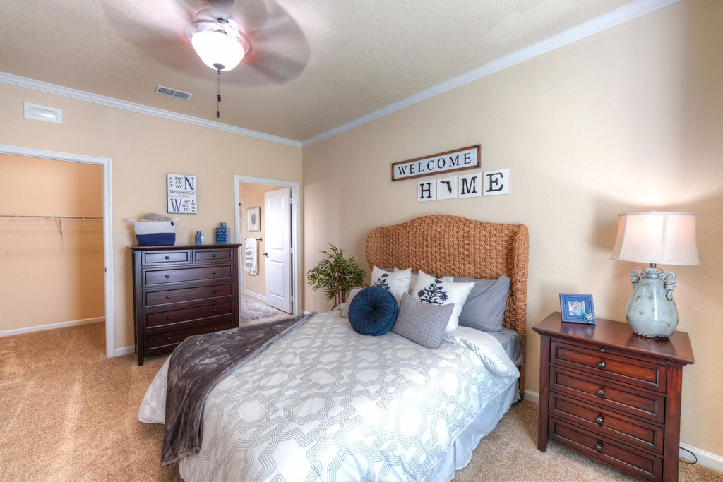 A bedroom with a bed, nightstand, and a ceiling fan at Cabana Club Apartments, Jacksonville, 32256