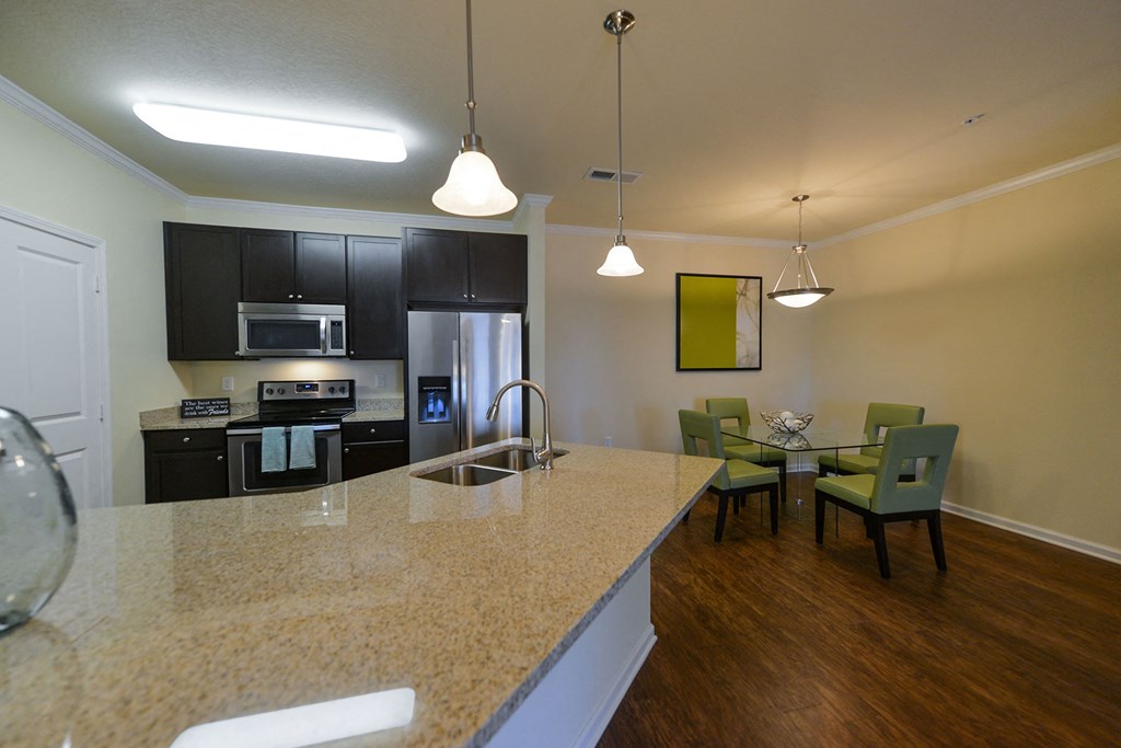 A kitchen with a table and chairs in front of it at Cabana Club Apartments, Florida 32256