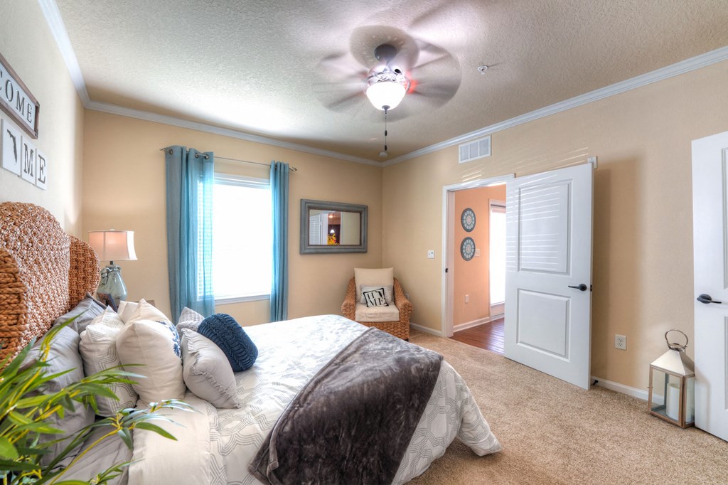 A bedroom with a large bed and a ceiling fan at Cabana Club Apartments, Jacksonville