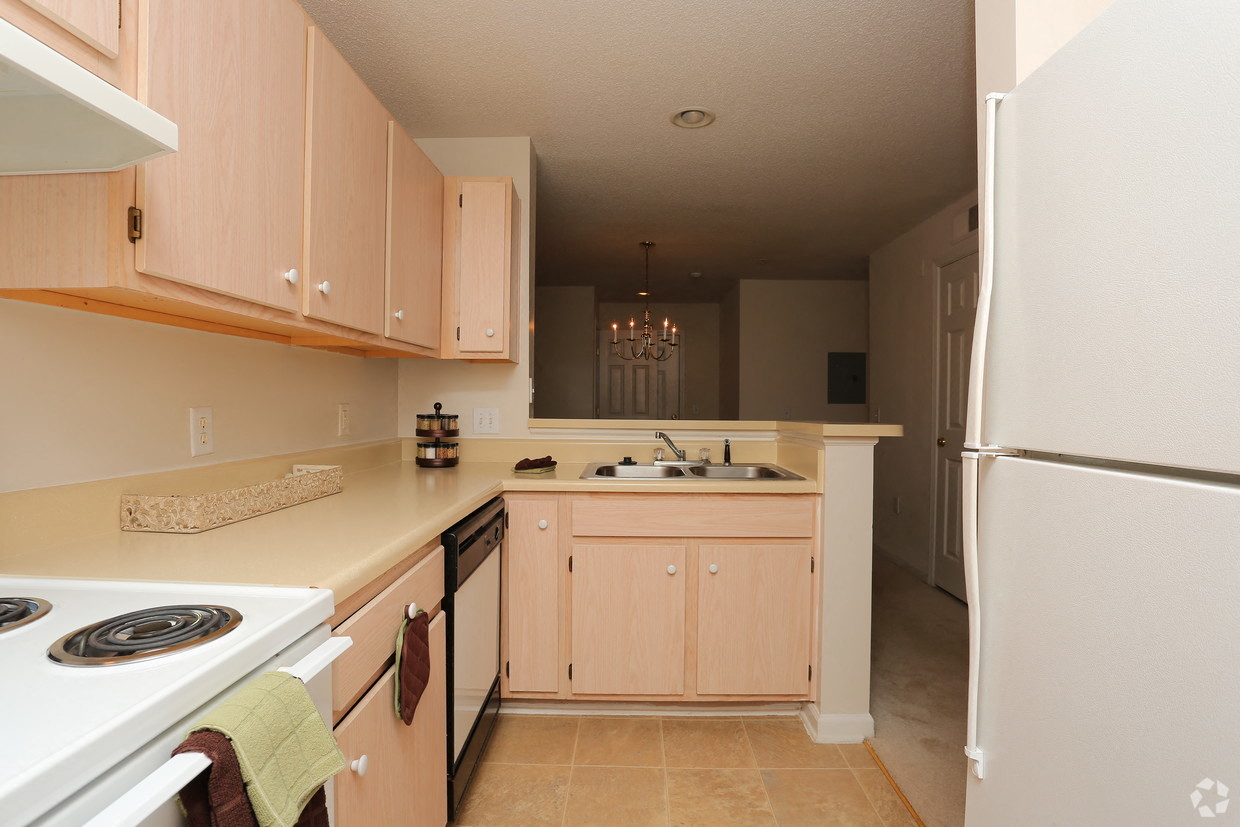 a kitchen with white appliances and wooden cabinets
