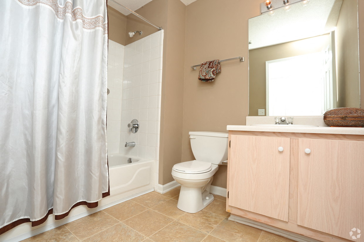 a bathroom with a shower toilet and a sink