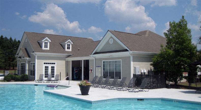 a large swimming pool in front of a house