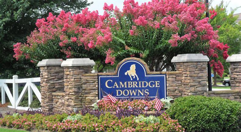 a sign downs in front of a brick wall