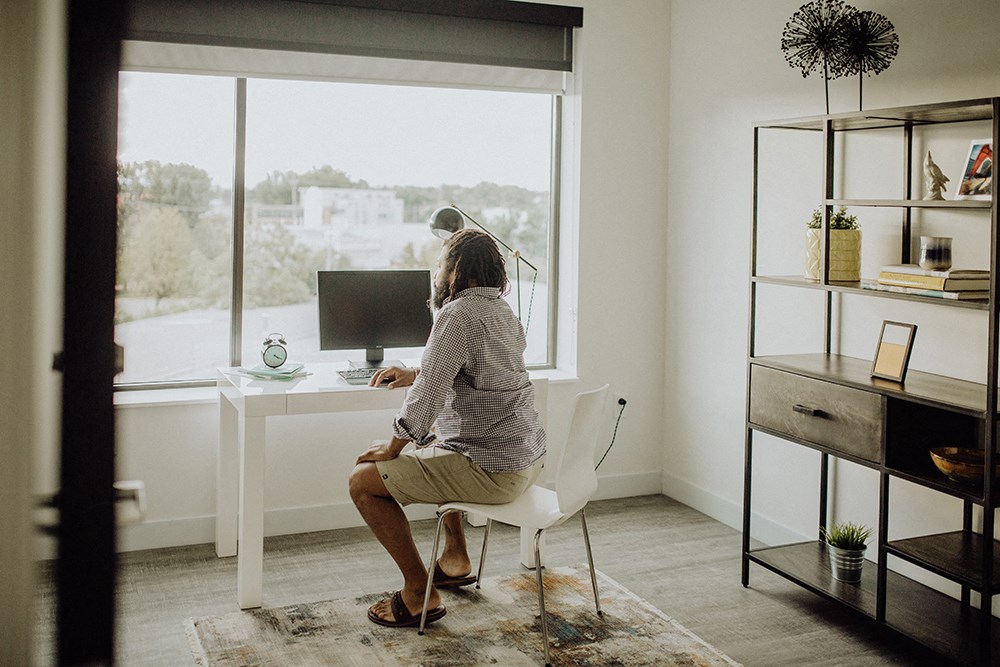 a woman sitting at a desk in front of a computer