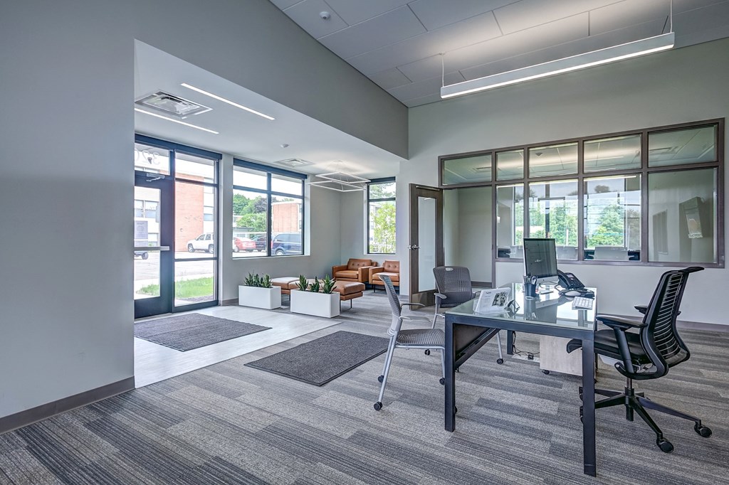 an office space with a glass desk and a computer
