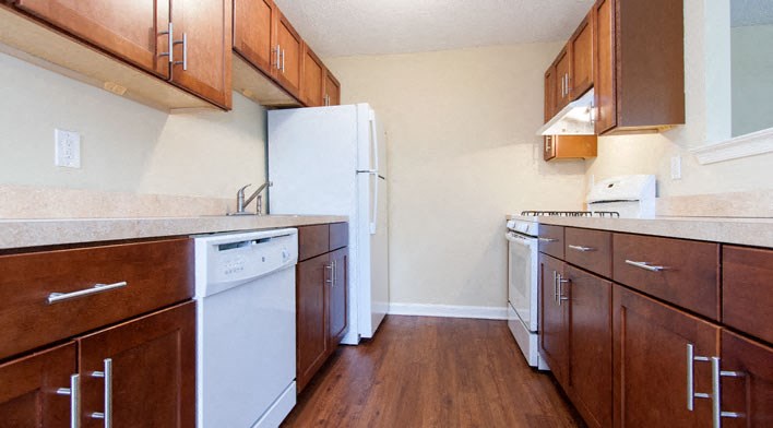 a kitchen with wooden cabinets and a white refrigerator