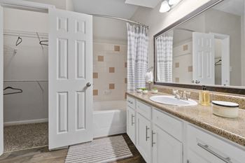 Luxury Package Includes: White cabinetry in kitchen & bathrooms, black appliance package, granite-style countertops, updated flooring, lighting & hardware,  two-tone designer paint & framed bathroom mirrors