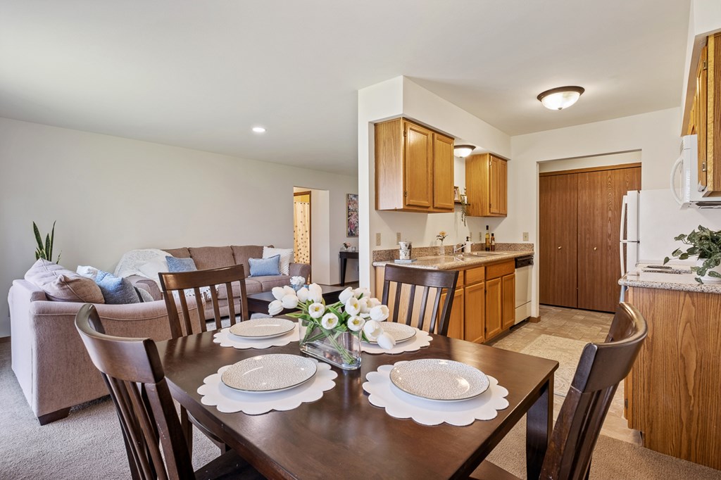 A dining room with a table set for two.
