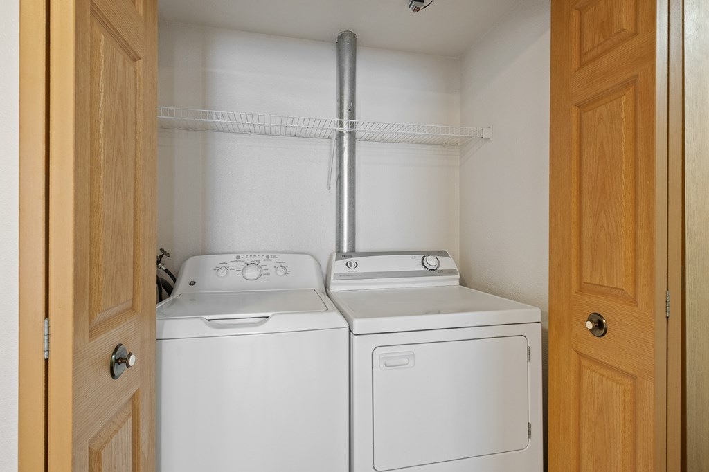 A small laundry room with a washer and dryer.