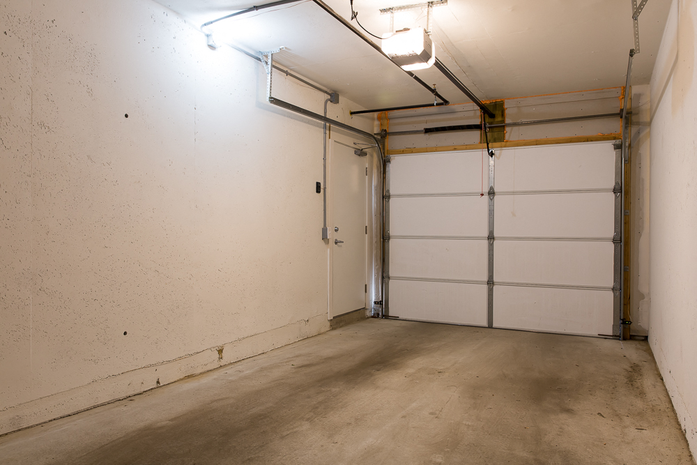 the inside of a garage with a white door
