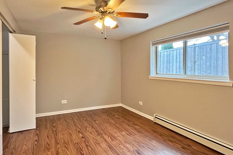 A room with a ceiling fan and a window.