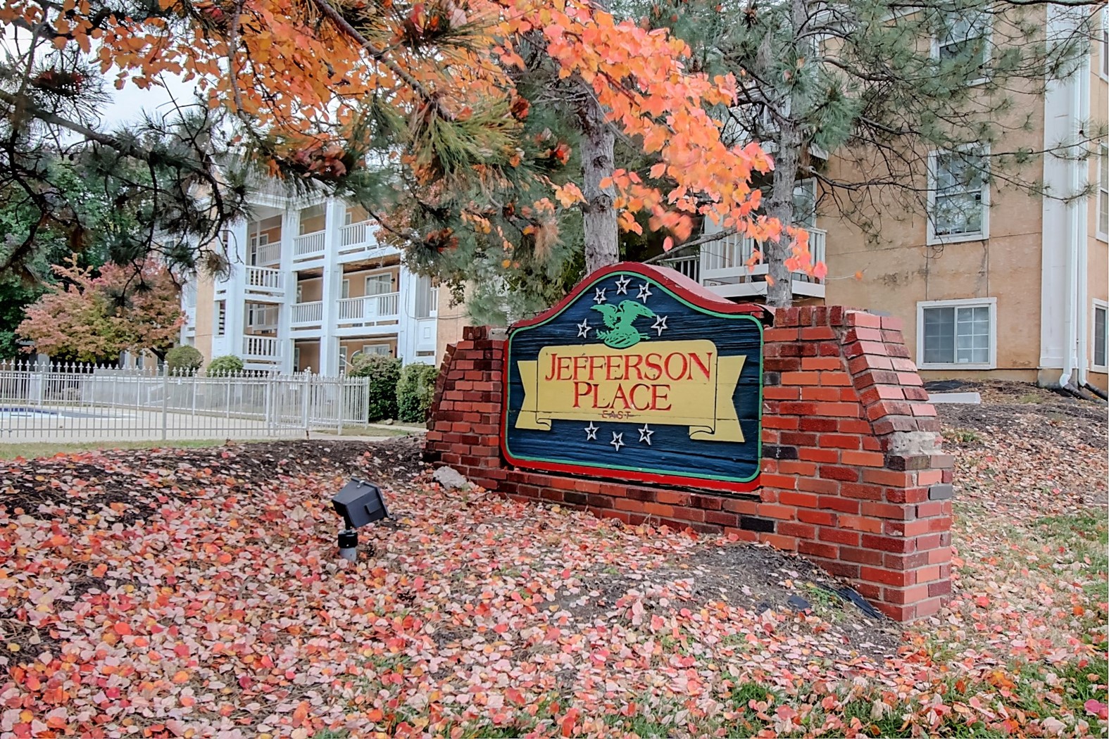 Image of Jefferson Place East sign with trees