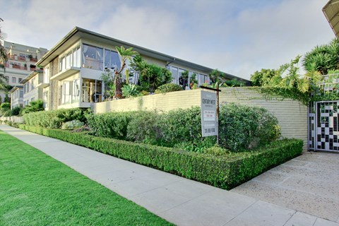 a house with a yard and a sign in front of it