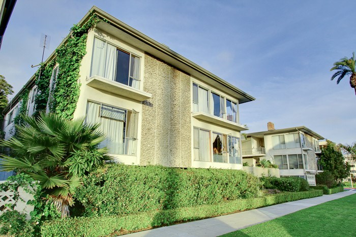 a large house with a sidewalk in front of it
