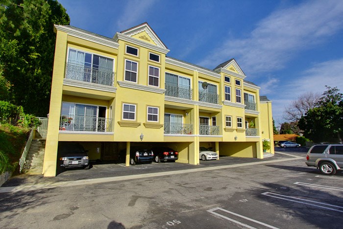 a yellow building with cars parked in front of it