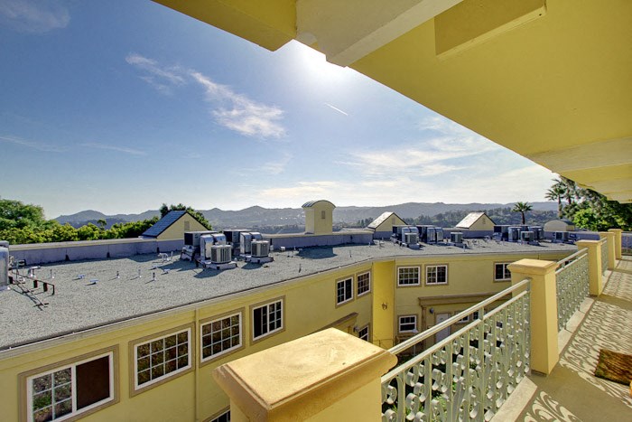 a view of the roof of a building from a balcony