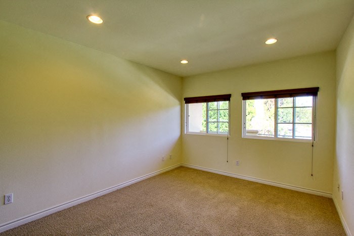 a large empty room with two windows