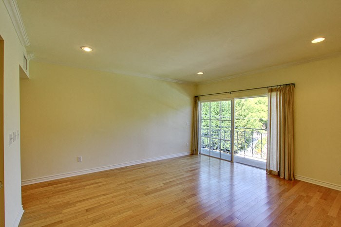 a living room with a wood floor and a sliding glass door