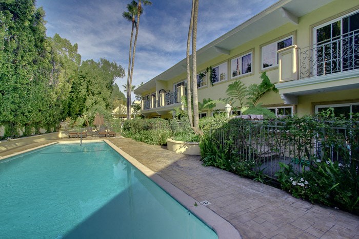 a large swimming pool in front of a house