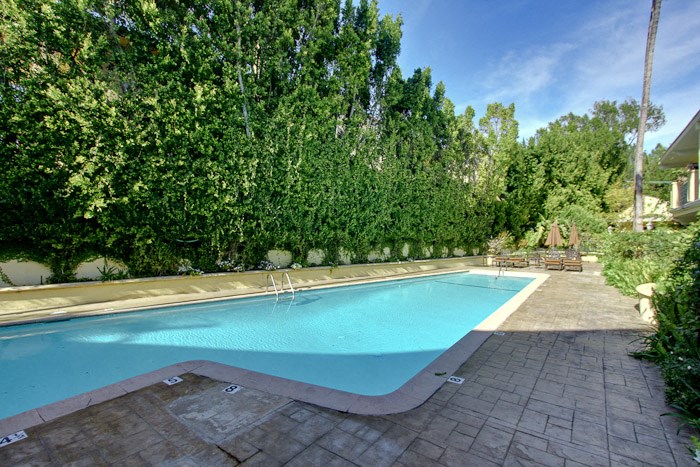 a swimming pool in the backyard of a house