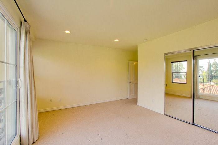 an empty living room with a sliding glass door