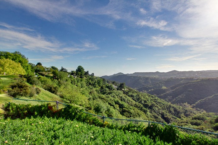 a view of the mountains and a suspension bridge