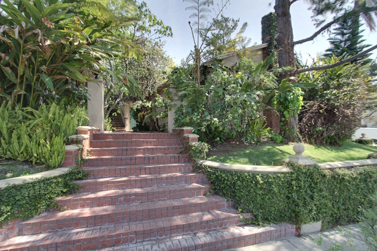 the steps up to the house are lined with plants