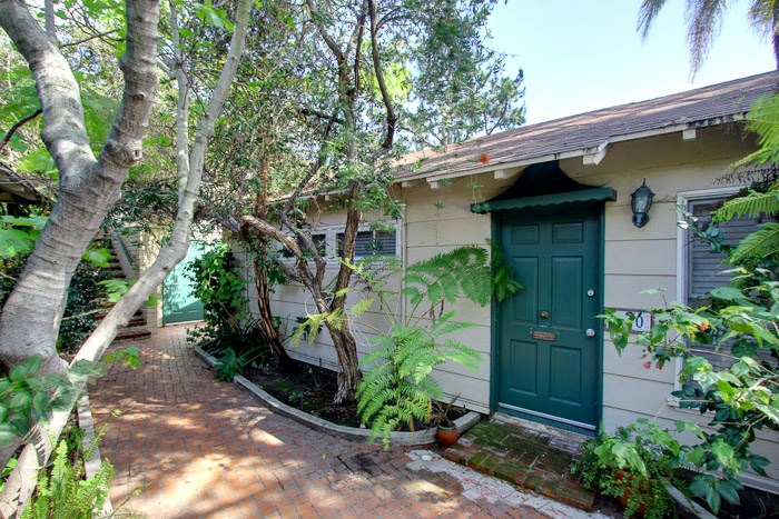 a small house with a green door