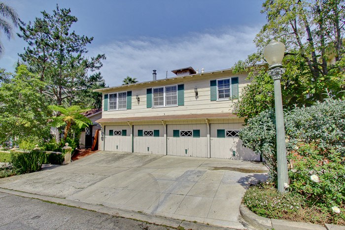 a white house with a driveway and a garage door