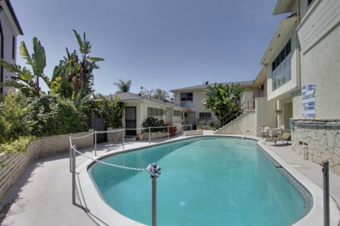 a swimming pool with apartments in the background