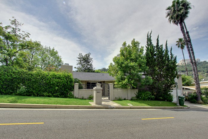 a house with a driveway and a street in front of it