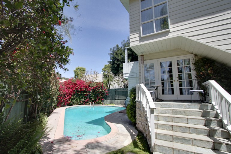 a house with a swimming pool in front of it