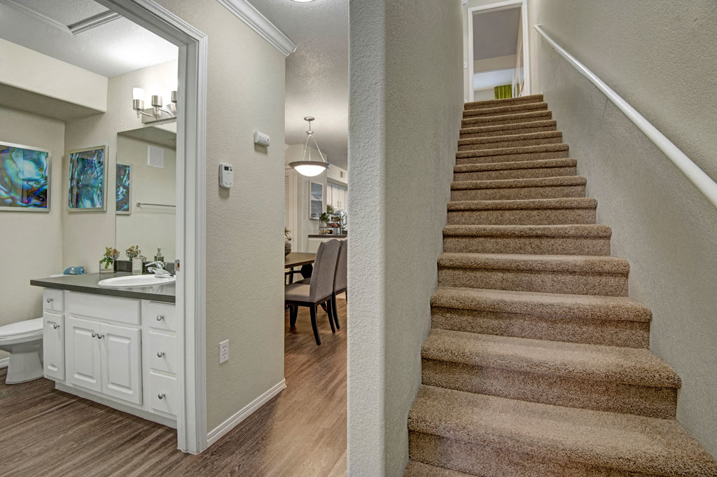 a view of a staircase in a home with a bathroom and a sink
