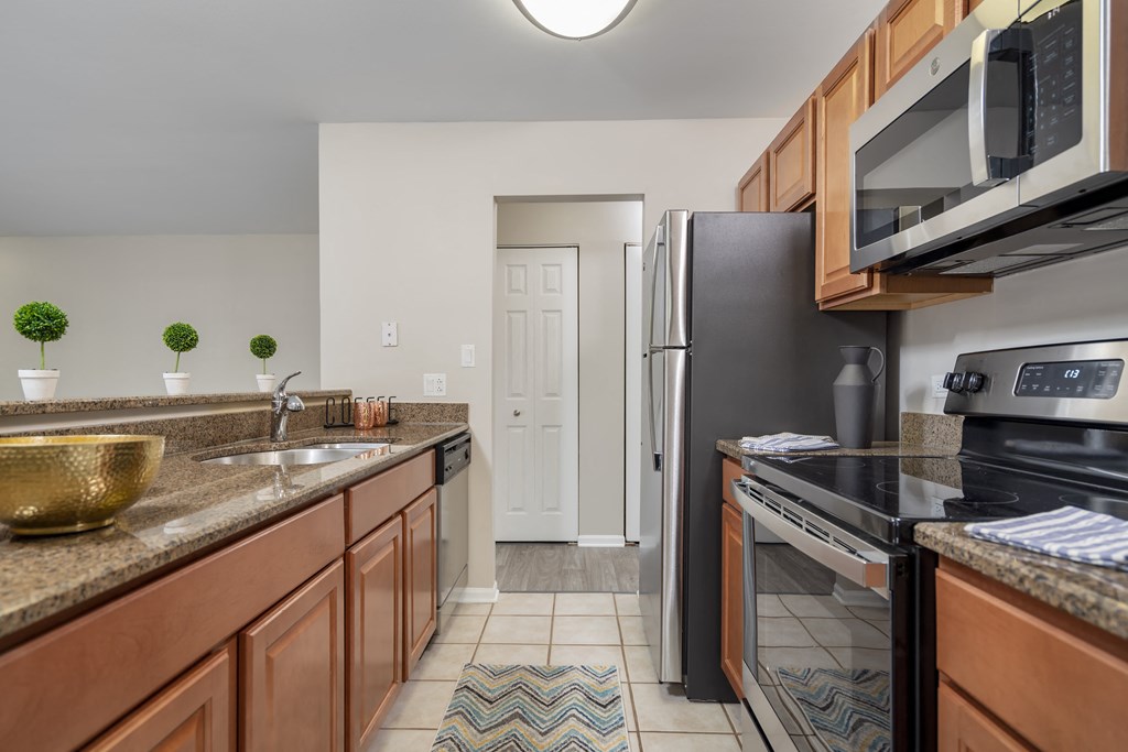 full kitchen with stainless steel appliances and granite counter tops at the reserve at walnut