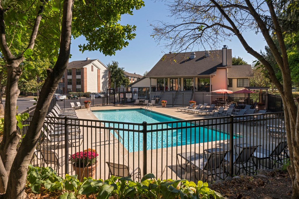 our apartments have a pool and a patio with chairs