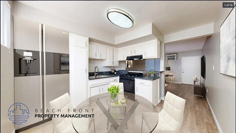 a white and black kitchen with a table and chairs