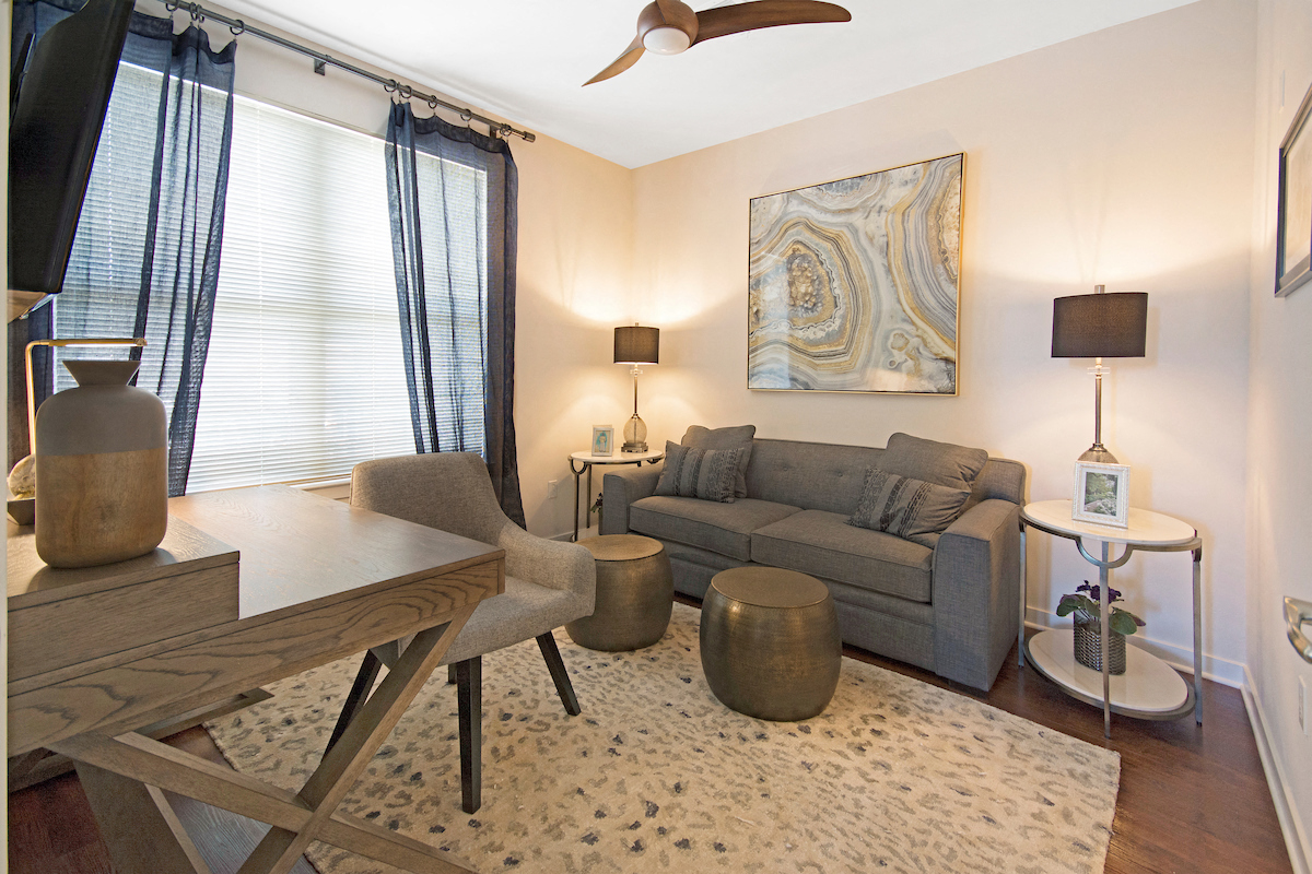 a living room with a couch and a dining table