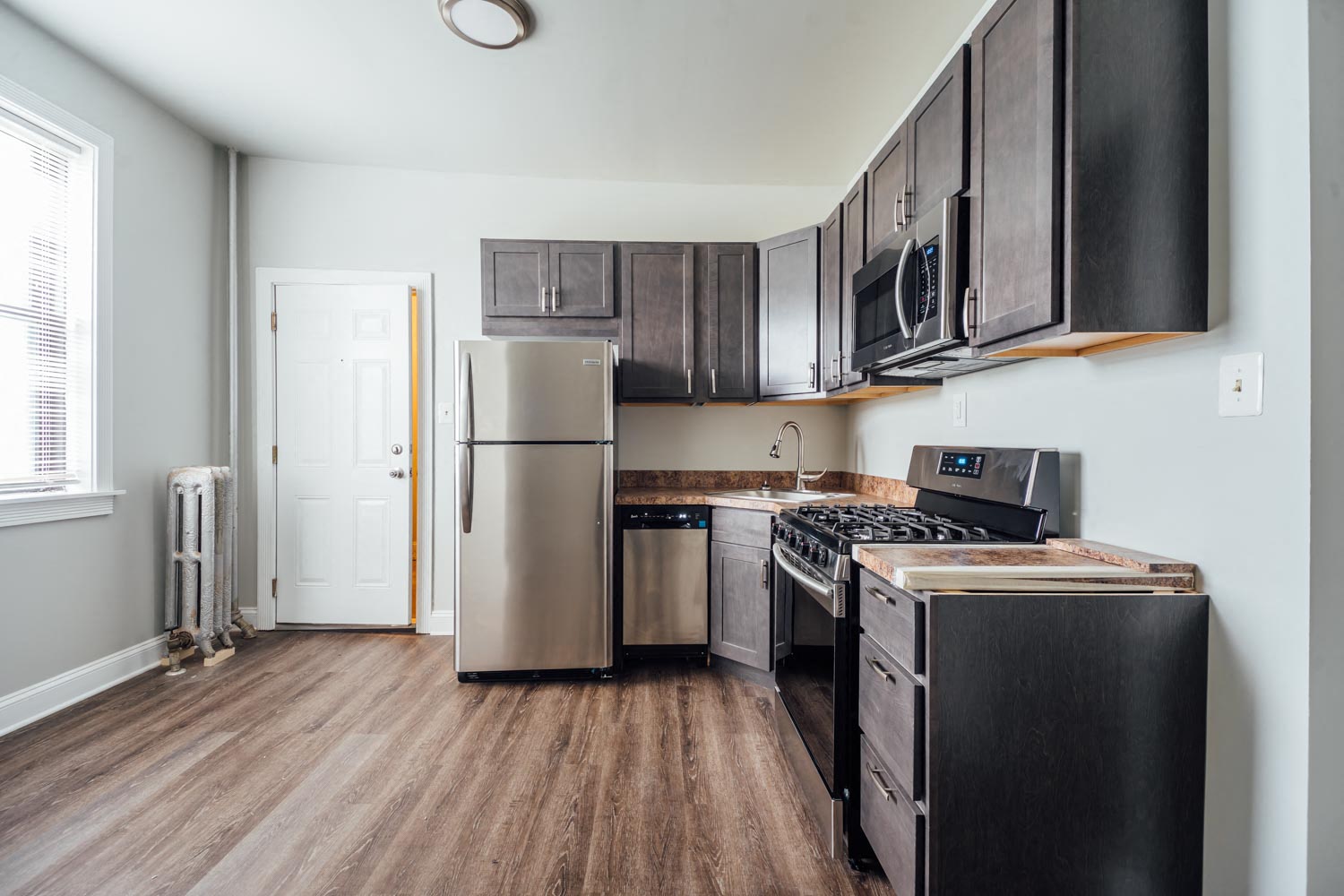 a kitchen with stainless steel appliances and black cabinets