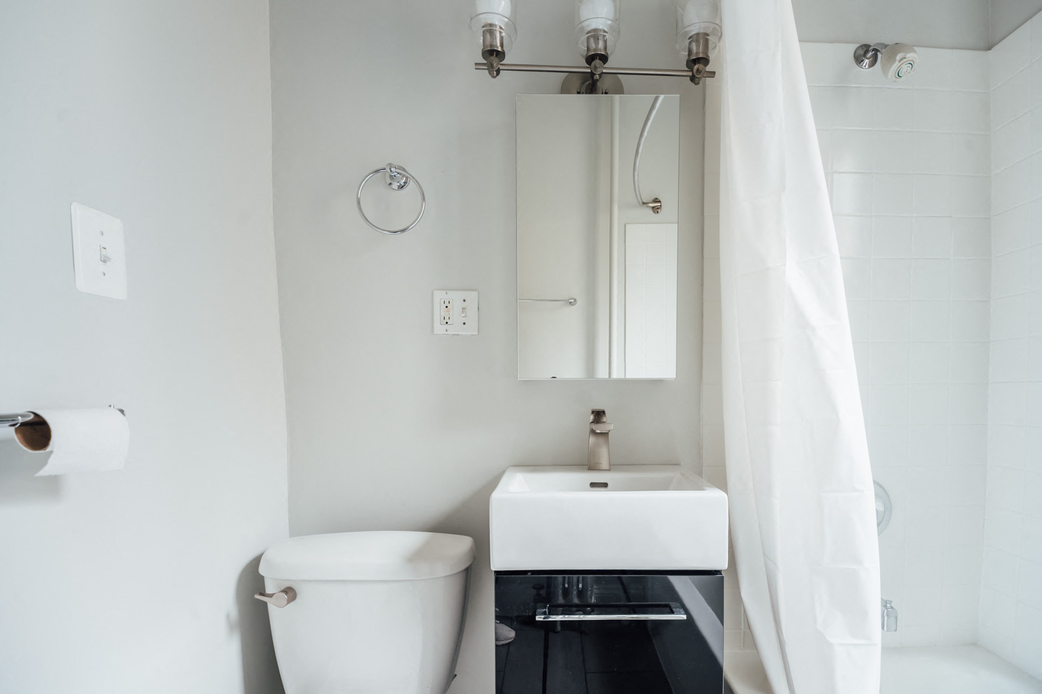 a small bathroom with a toilet and a sink and a mirror