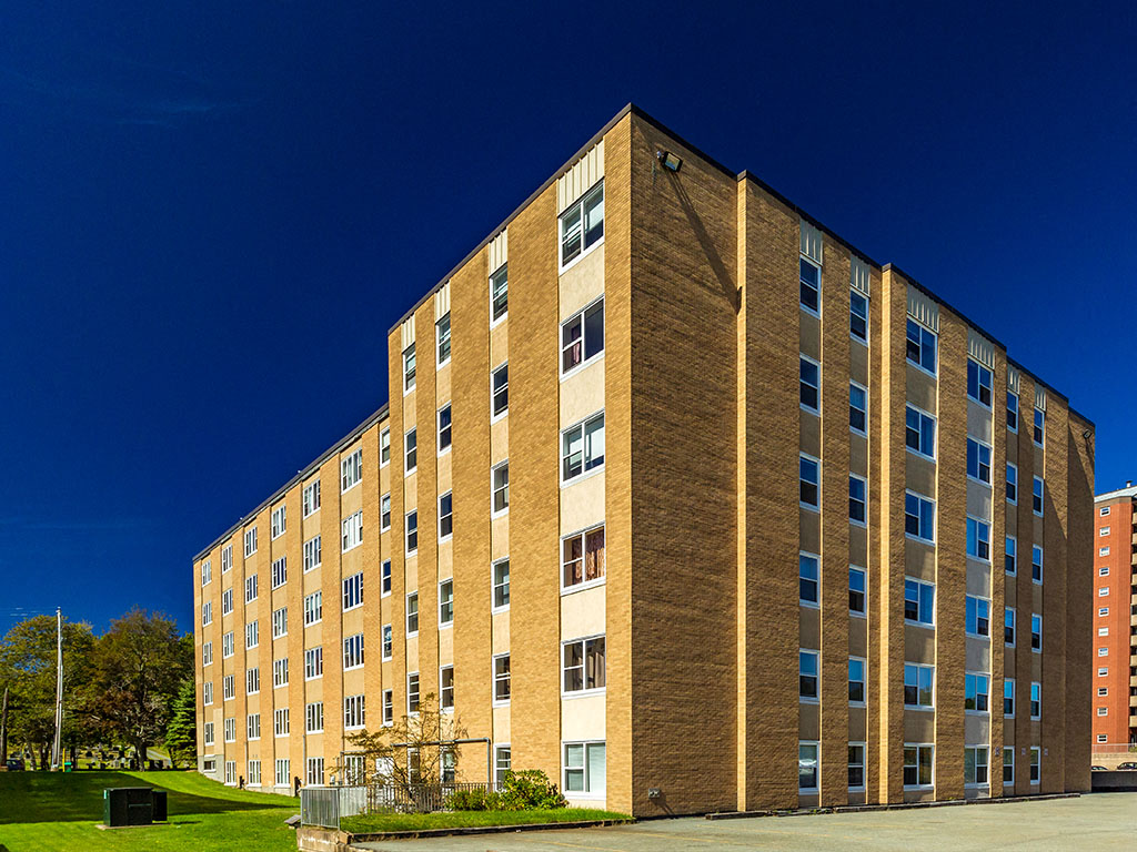 a large brick building against a blue sky