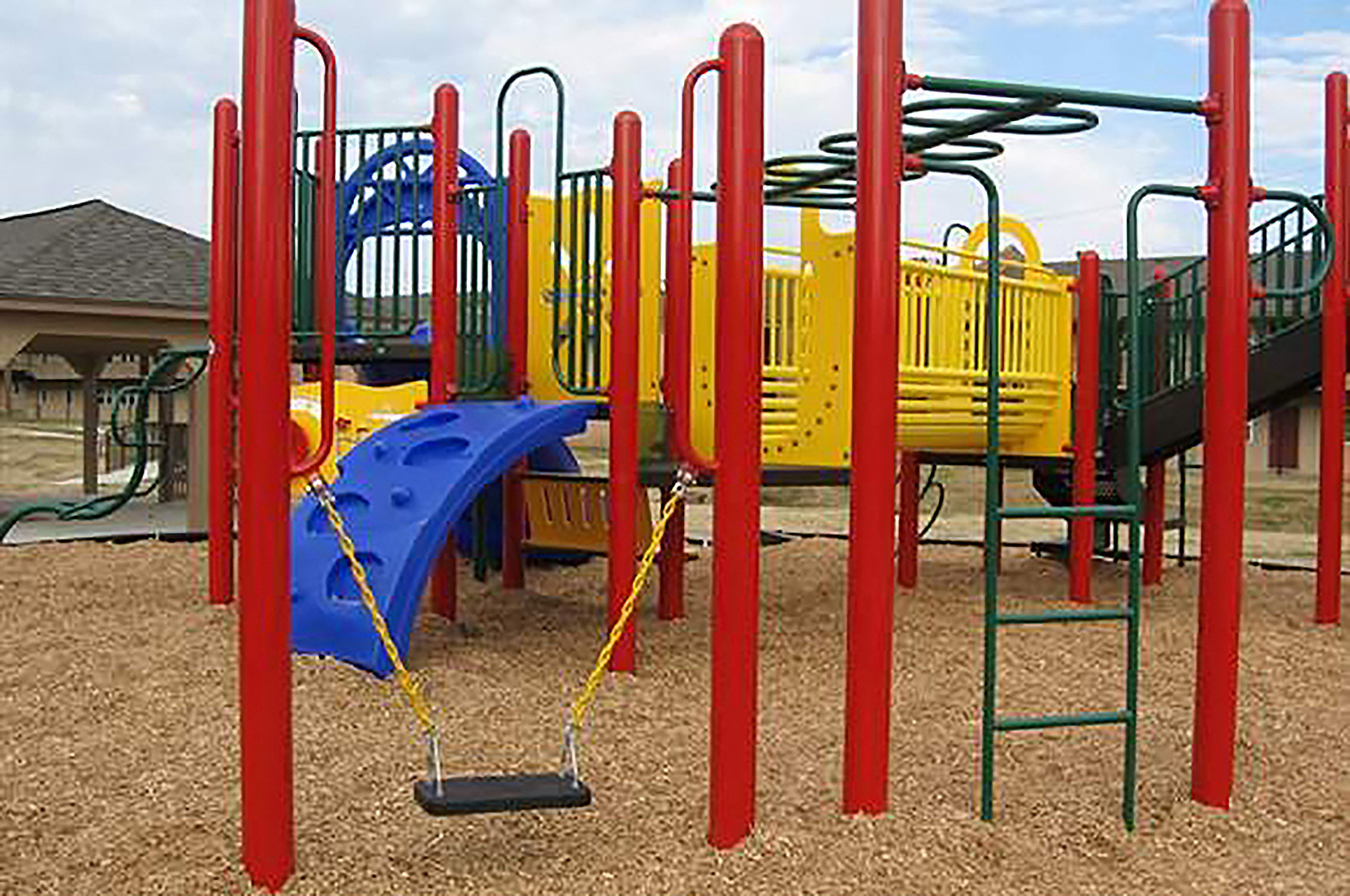 a playground with a blue slide and yellow slide