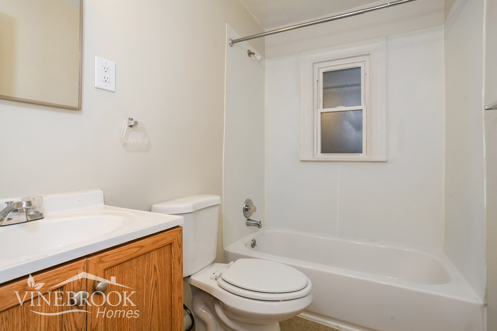 a bathroom with a toilet and a tub and a sink